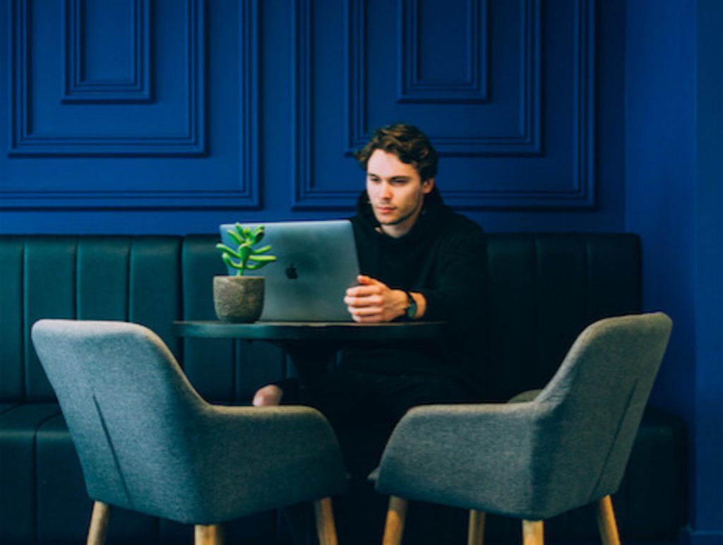 man at table with laptop 